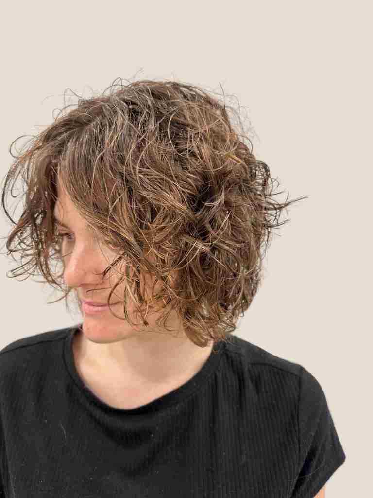 Client with short curly hair showcasing their fresh haircut at Second Avenue Hair, a top Melbourne curly hair salon